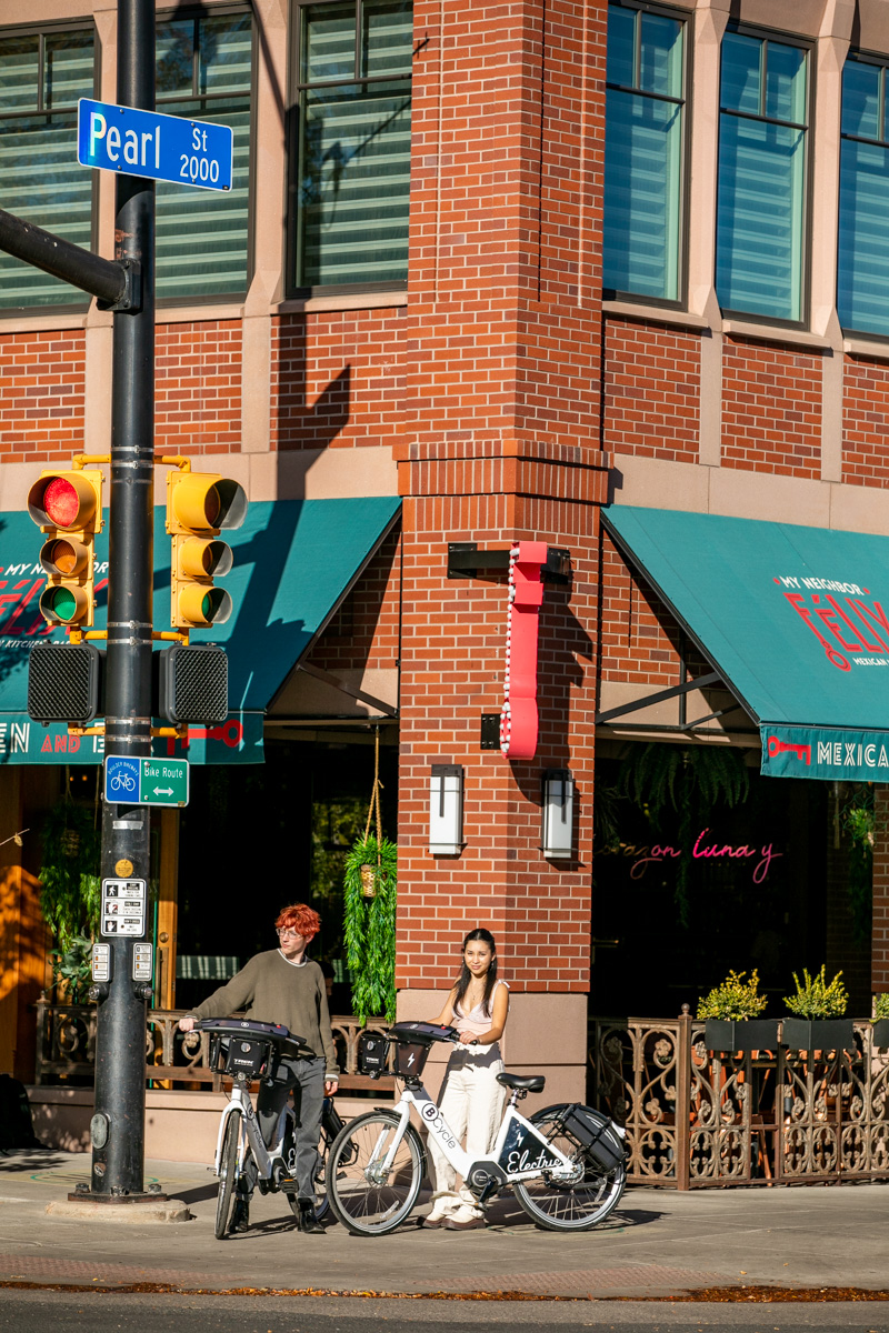 Commuting on ebikes on Pearl Street  in Boulder, Colorado and photography by Julia Vandenoever.